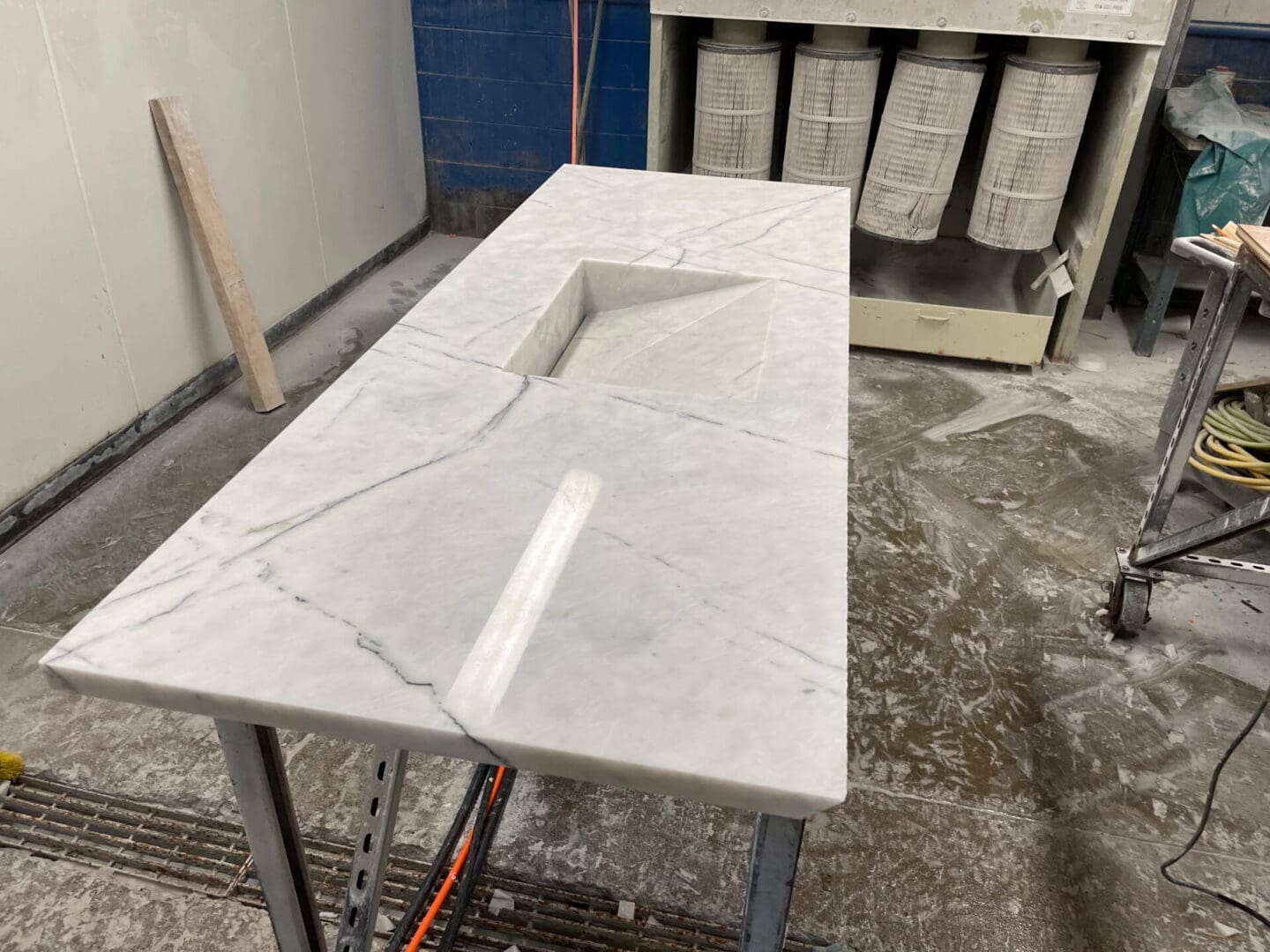 Marble countertop with integrated sink in workshop