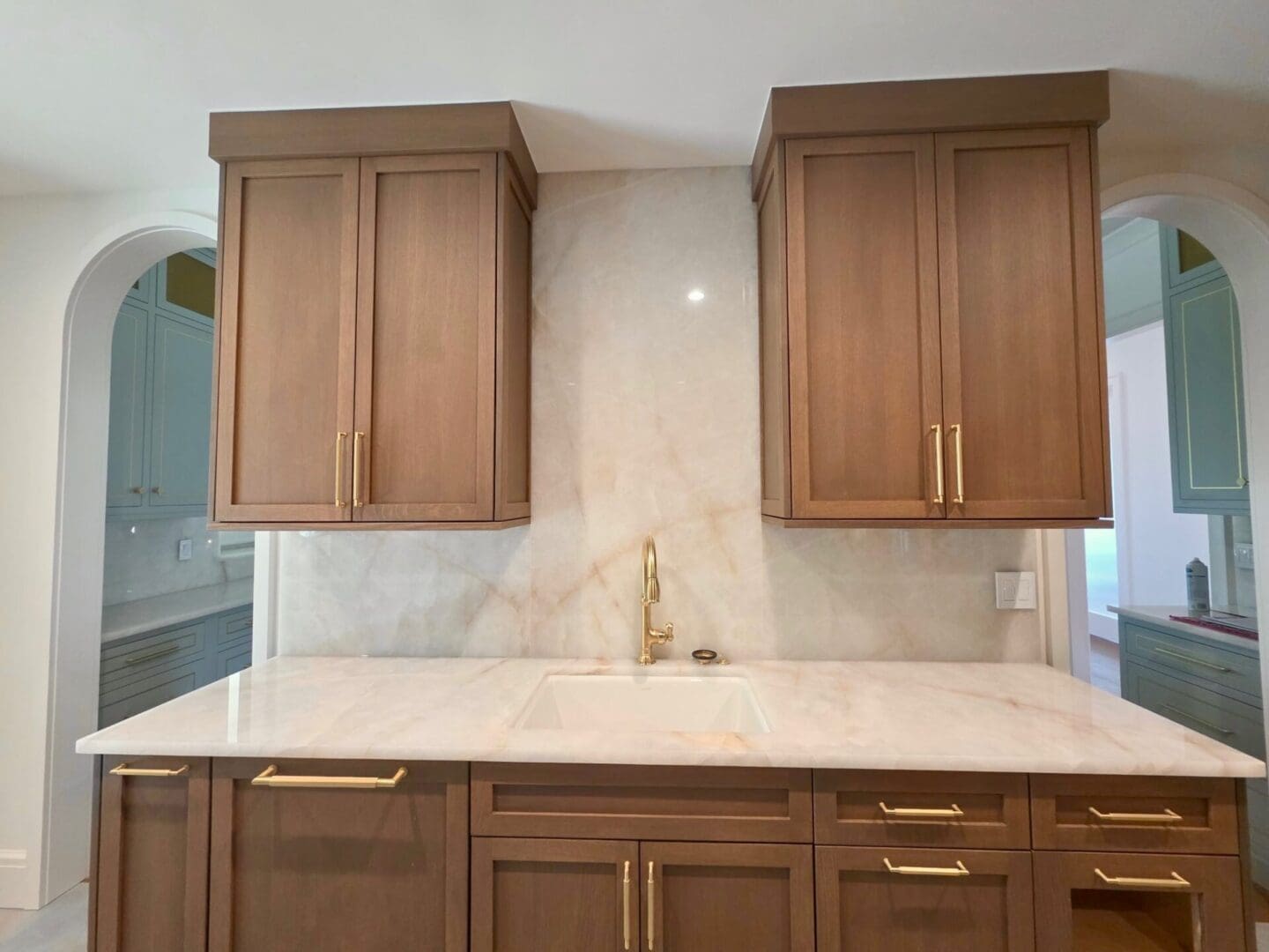 Kitchen marble countertop with brass faucet and cabinets