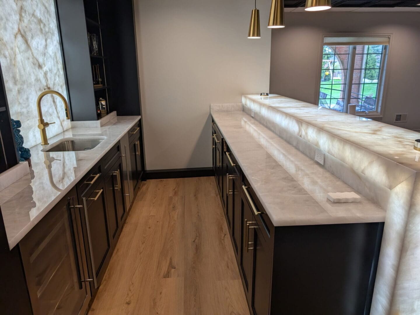 Modern kitchen with marble counters and gold fixtures