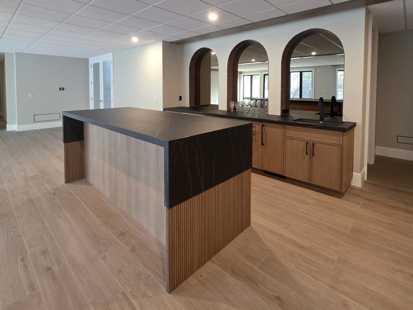 Contemporary wood island with arched mirrors