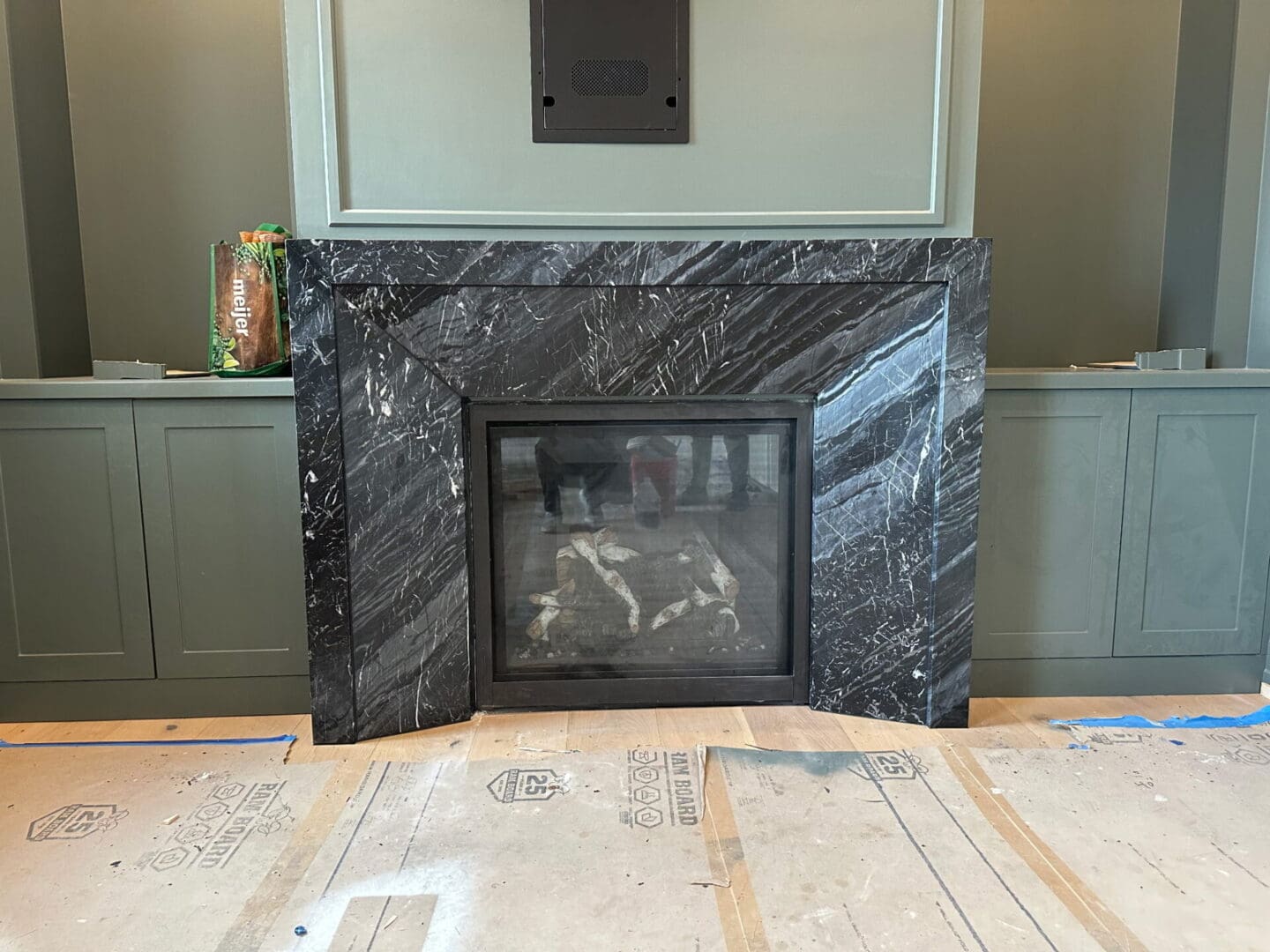 Black marble fireplace in unfinished room