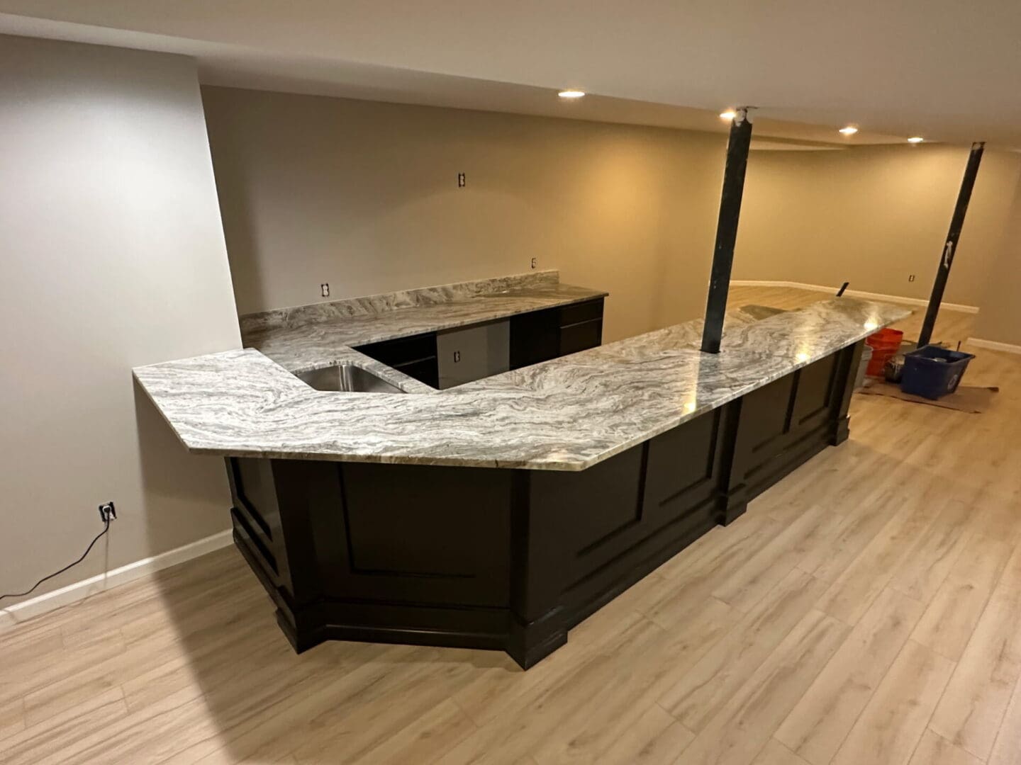 Basement L-shaped bar with marble countertop