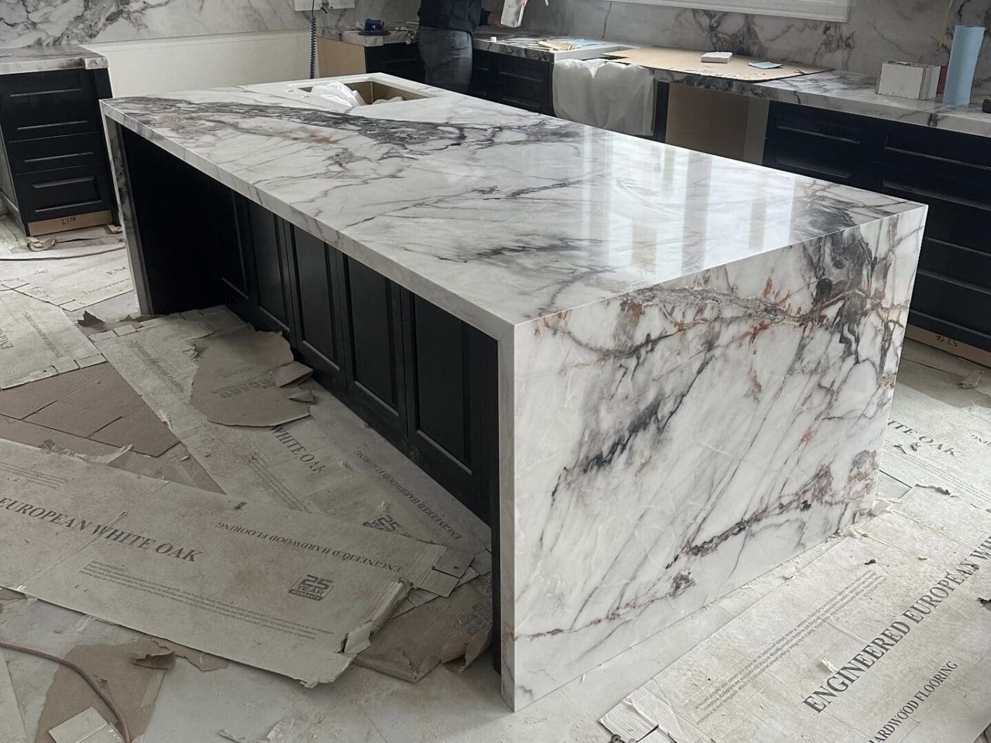 Marble kitchen island being installed during renovation
