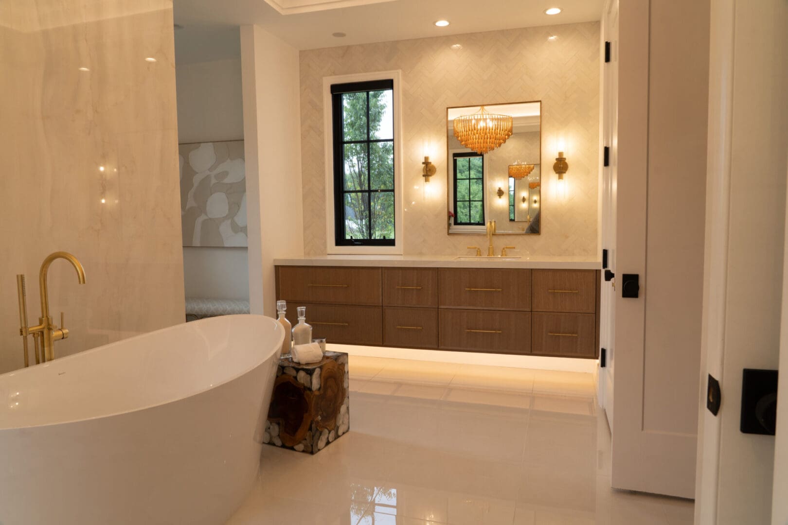 Elegant bathroom with freestanding tub and chandelier