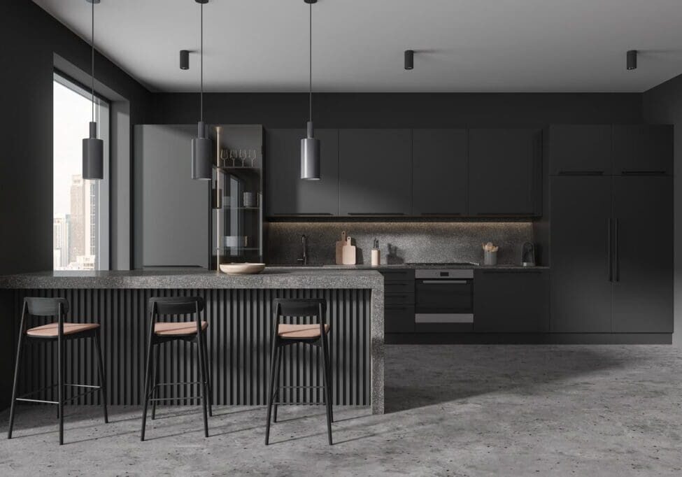 Modern kitchen with dark cabinetry, a large island with stools, pendant lighting, and built-in appliances. A window allows natural light to enter, illuminating the space.